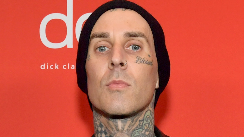 Travis Barker poses at an event