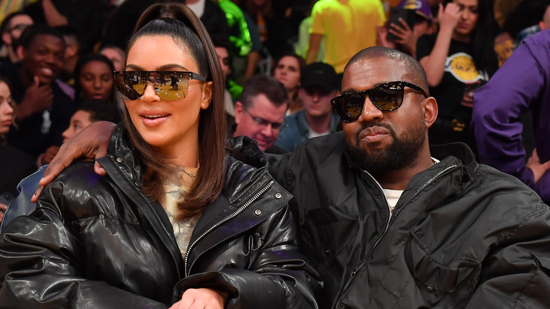 Kim Kardashian and Kanye West on the sidelines