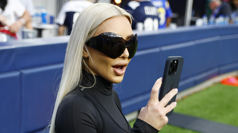 Kim Kardashian looking at phone