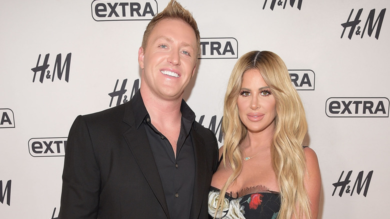 Kroy Biermann and Kim Zolciak pose 