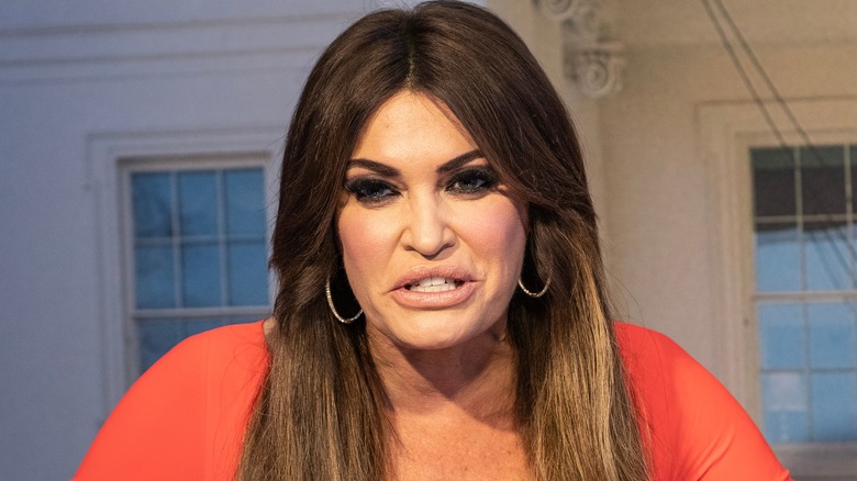 Kimberly Guilfoyle wearing an orange dress