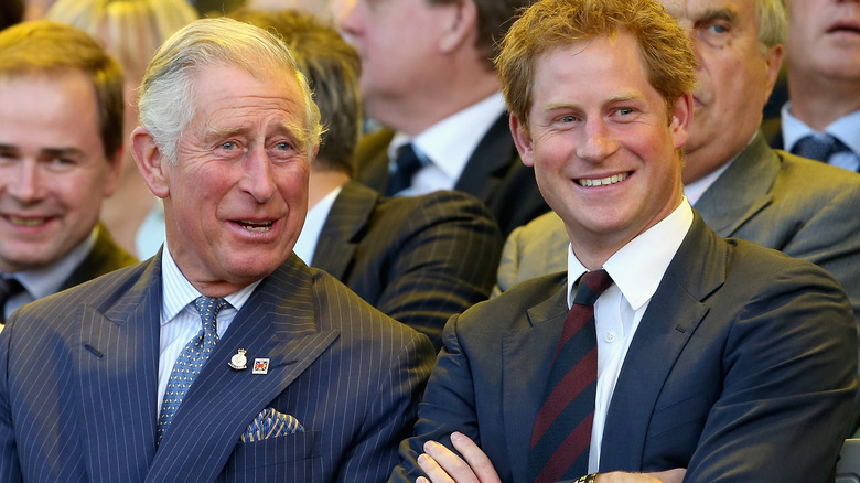 King Charles and Prince Harry smiling