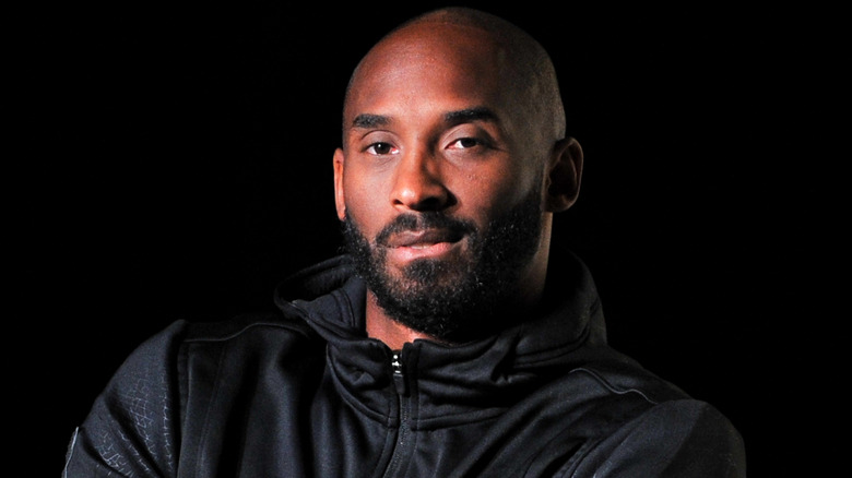 Kobe Bryant posing in black jacket