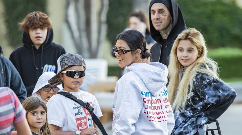 Kourtney Kardashian and Travis Barker hanging out with their kids Landon, Alabama, Mason and Penelope