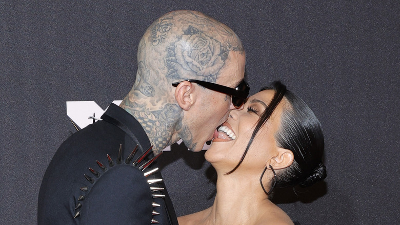 Travis Barker and Kourtney Kardashian touching tongues