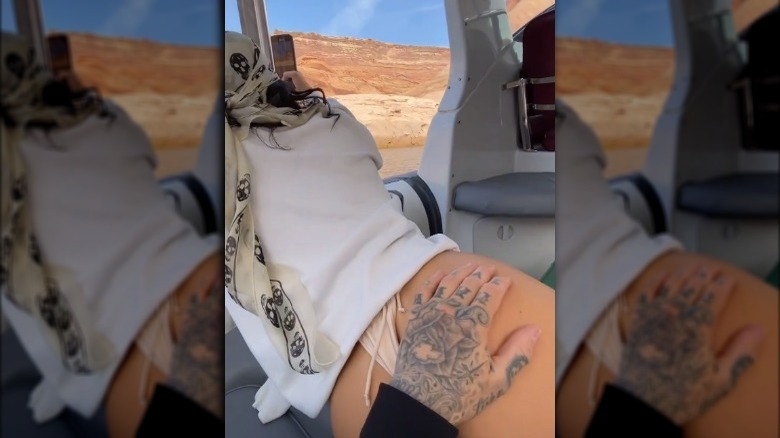 Travis Barker's hand on Kourtney Kardashian's bum