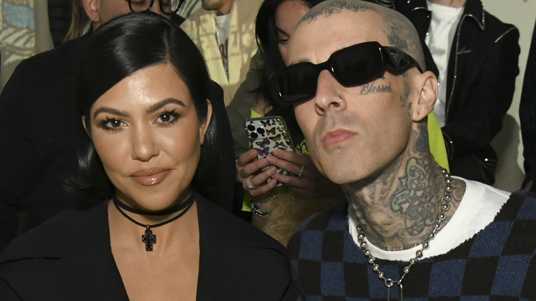 Kourtney Kardashian and Travis Barker attend runway show