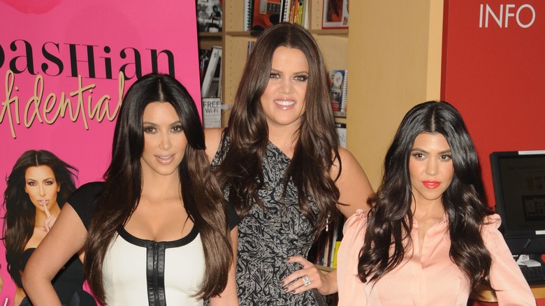 Kim Kardashian, Khloe Kardashian, and Kourtney Kardashian posing