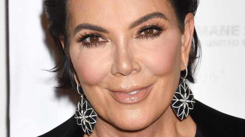 Kris Jenner poses with flower earrings.