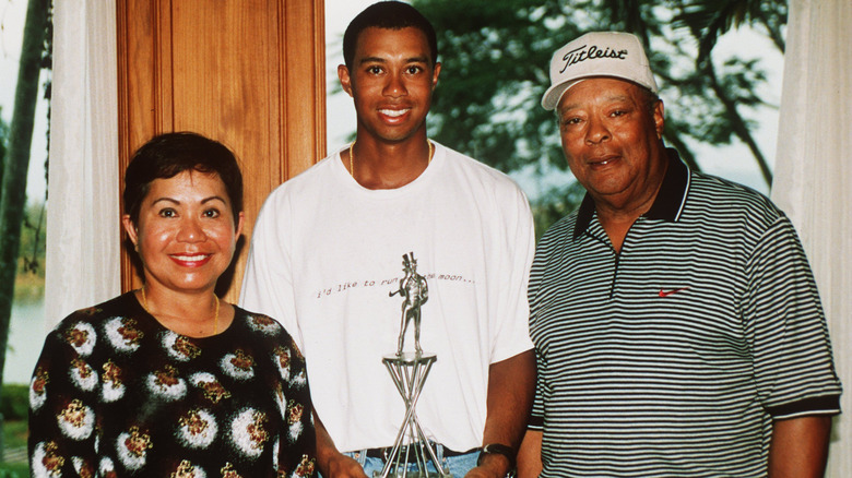 A younger Tiger Woods with his parents