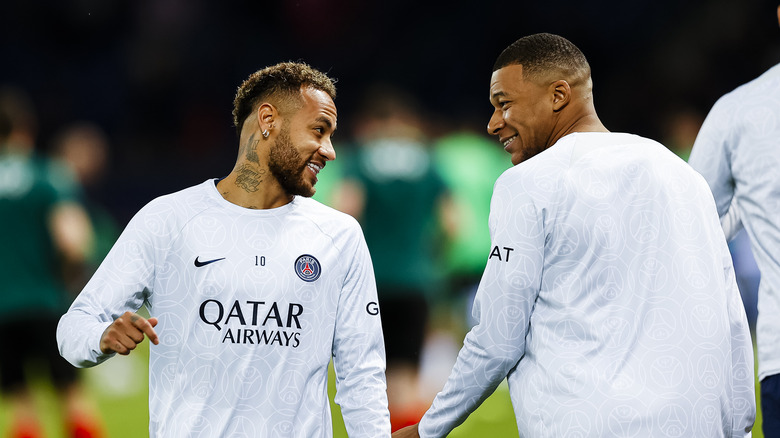 Kylian Mbappé smiles at Neymar