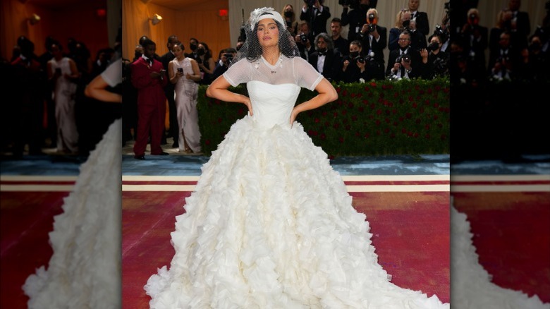 Kylie Jenner posing in wedding dress, ball cap