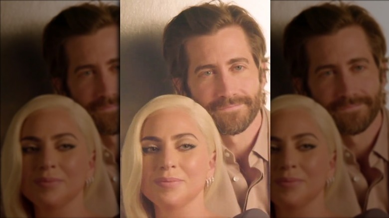 Jake Gyllenhaal holding Lady Gaga smiling