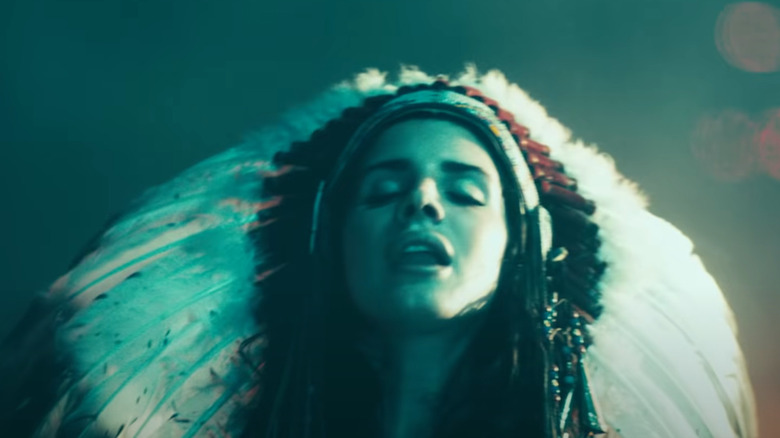 Lana Del Rey wearing a Native American headdress