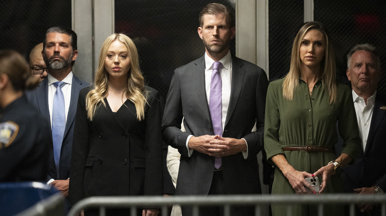 Members of the Trump family with somber expressions