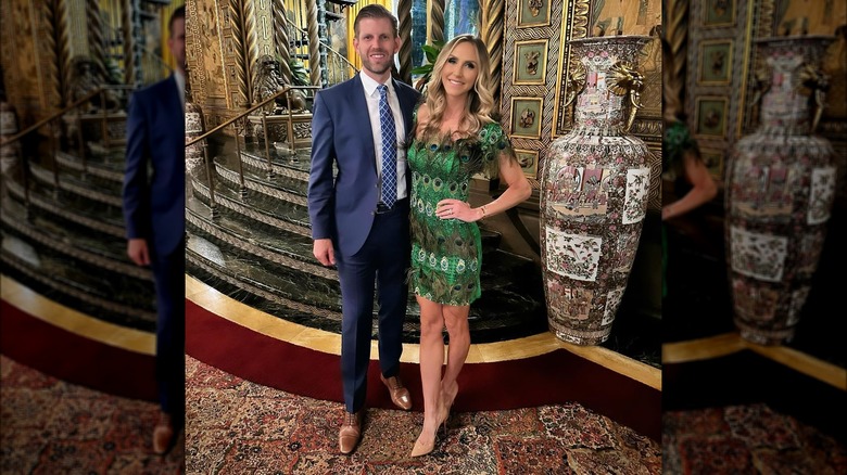 Eric, Lara Trump posing beside large vase