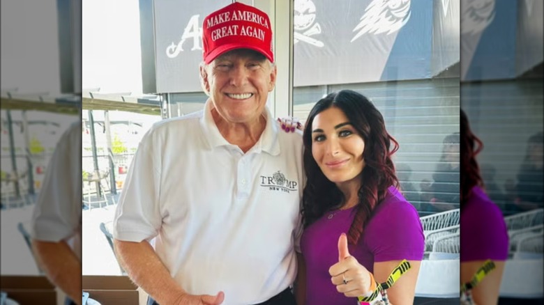 Laura Loomer posing Donald Trump