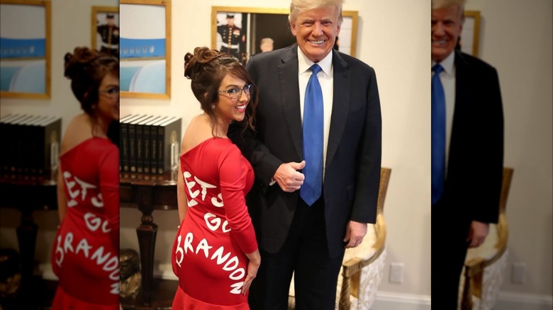 Lauren Boebert posing in a Let's Go Brandon dress with Donald Trump