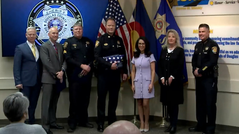 Lauren Boebert posing with Douglas County police officers and Tamara Dean Harney