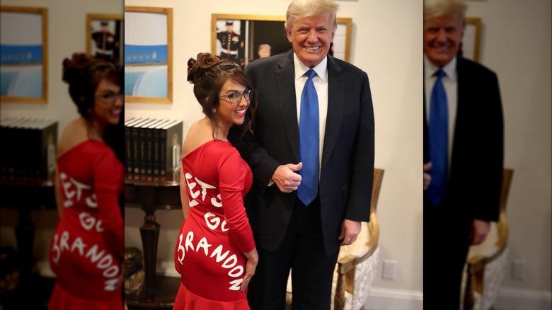 Lauren Boebert posing with Donald Trump in a Let's Go Brandon dress