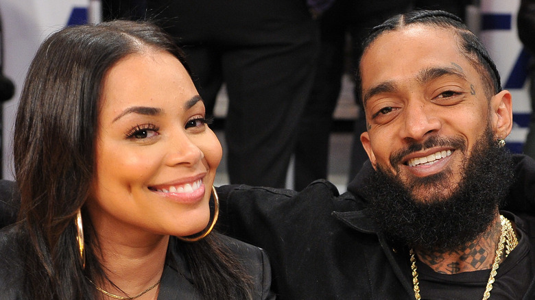 lauren london and nipsey hussle at a basketball game 