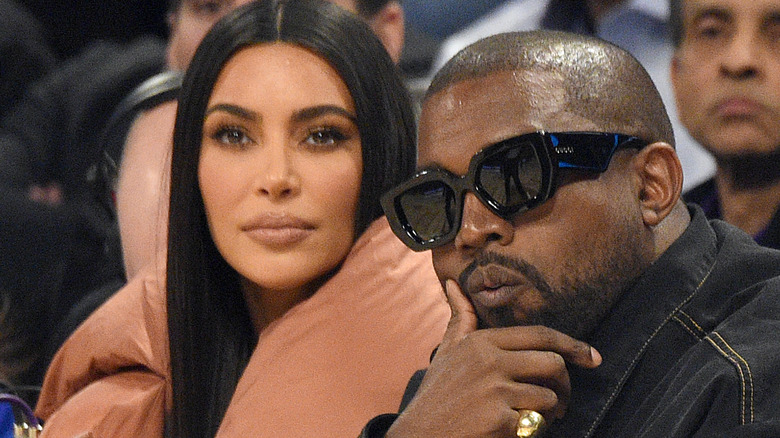 Kim Kardashian and Kanye West posing 