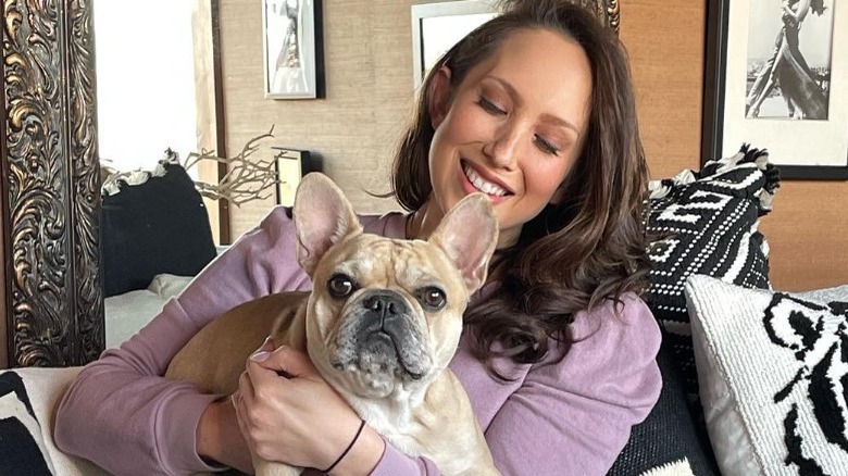 Cheryl Burke holding her dog