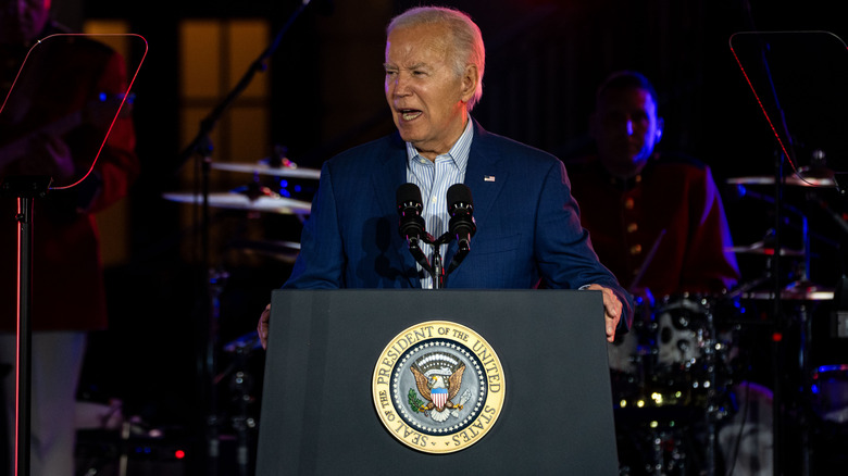 Joe Biden blue suit speaking at podium