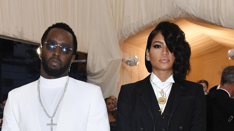 Sean Diddy Combs and Cassie Ventura stand together with serious faces