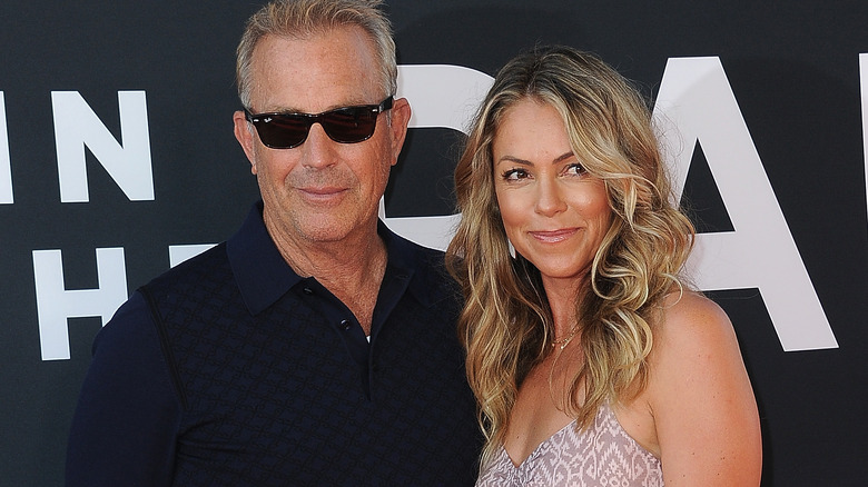 Kevin Costner and Christine Baumgartner smiling