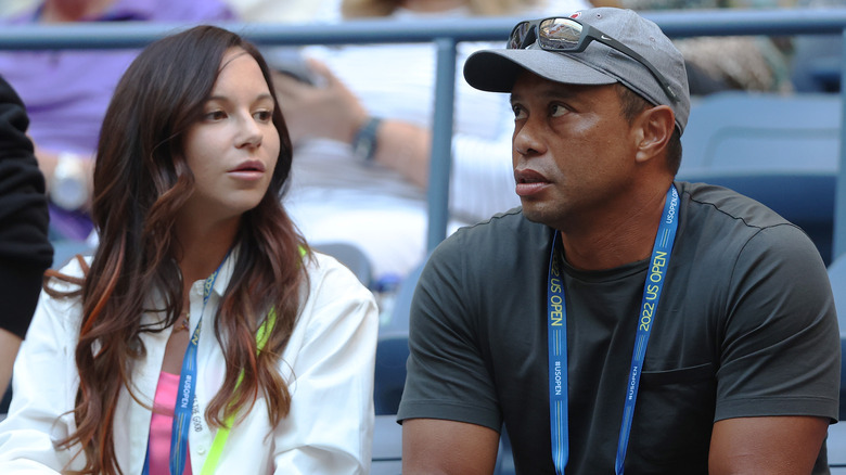 Erica Herman and Tiger Woods seated in stadium