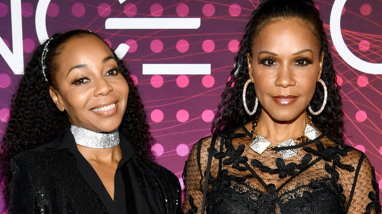 Terry Ellis and Cindy Herron standing in front of a purple background