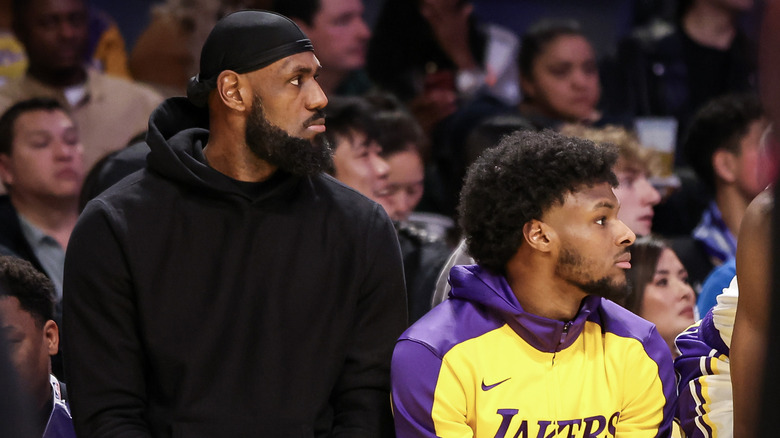 LeBron James and Bronny James watch a Lakers game