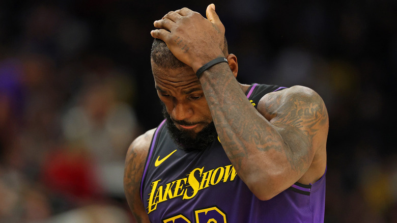 LeBron James on a basketball court hand on head