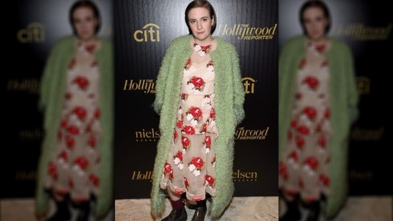 Lena Dunham in green coat and floral dress