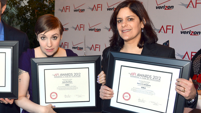 Lena Dunham and Ilene Landress pose together with awards