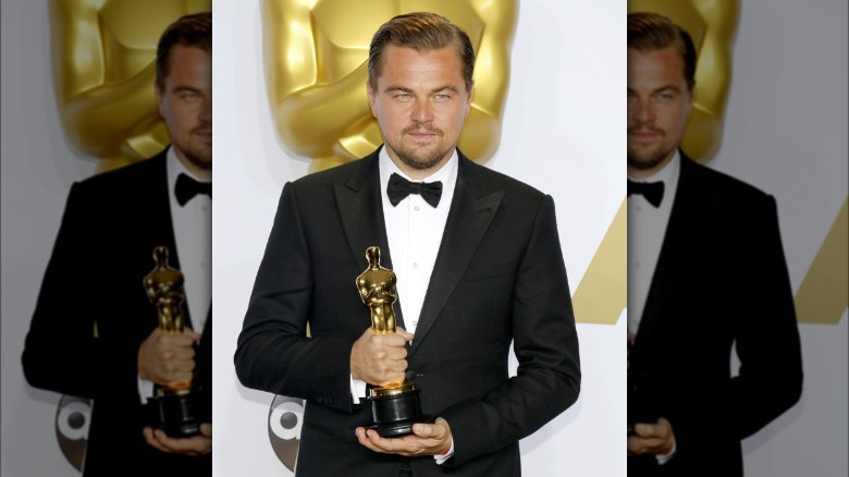 Leonardo DiCaprio holding his Oscar