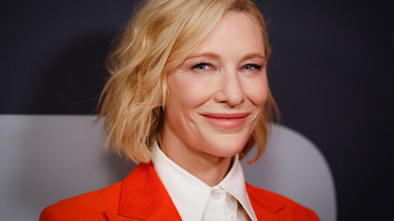 Cate Blanchett smiling in orange suit