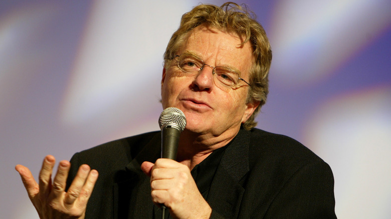 Jerry Springer, holding a microphone