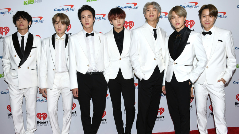 BTS posing in matching tuxedos