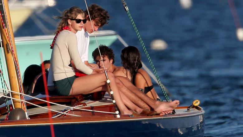 Taylor Swift and Conor Kennedy sitting on a boat
