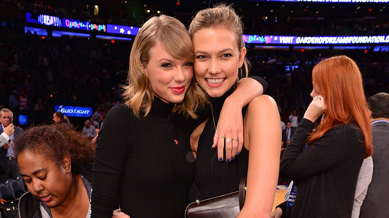 Taylor Swift with arm around Karlie Kloss