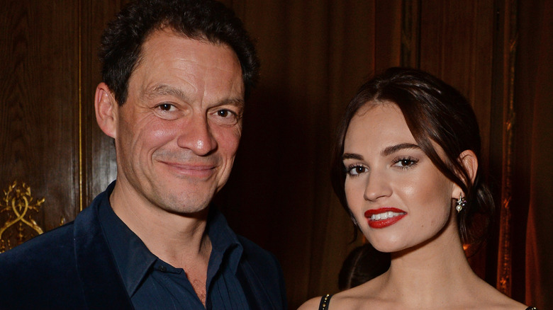 Lily James posing with Dominic West