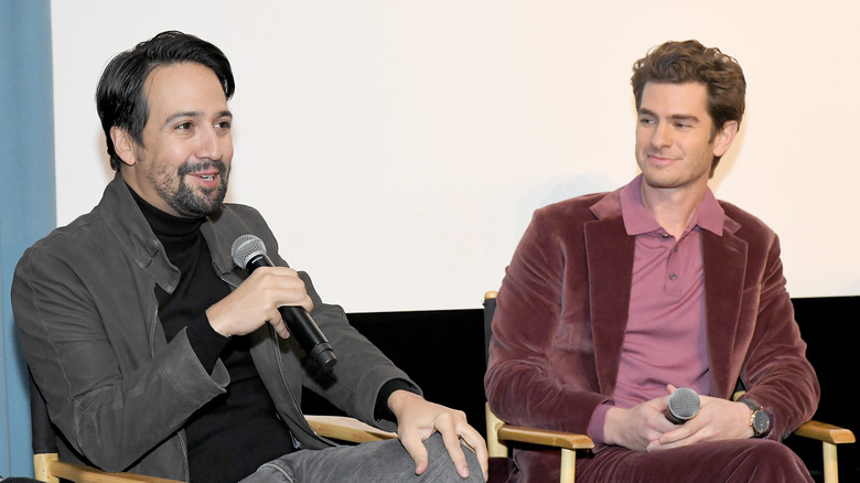 Lin-Manuel Miranda and Andrew Garfield talking on-stage at an event