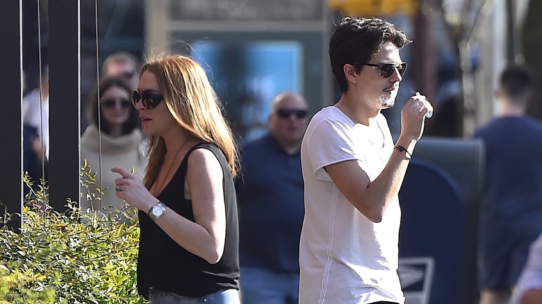 Lindsay Lohan and Egor Tarabasov walk down the sidewalk