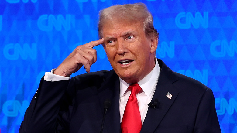 Donald Trump with finger on forehead