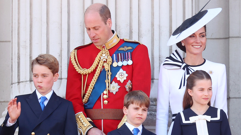 Prince William, Kate Middleton standing behind their children