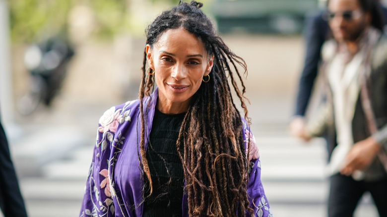 Lisa Bonet smiling wearing purple