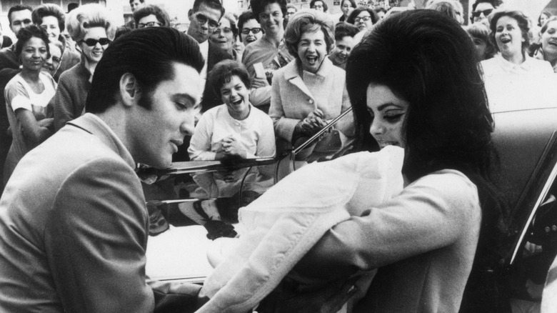 Elvis, Priscilla and Lisa Marie Presley at an event 