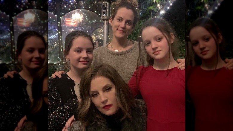 Lisa Marie Presley posing with daughters